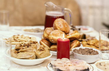 Traditional Christmas table in Ukraine, twelve meatless dishes: kutya, stewed fruit, beet soup, dumplings, mushroom picking, fried fish, herring, pickled mushrooms, beet salad, donuts, garlic