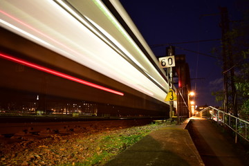 Train in night on bridge.