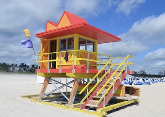 Fototapeta na wymiar Brightly color orange and yellow ocean-rescue station on the beach in the south beach section of Miami Beach,Florida