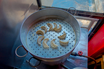 Top view of delicious momo food over a metallic tray in the kitchen, type of South Asian dumpling native to Tibet, Nepal, Bhutan and Sikkim in Nepal