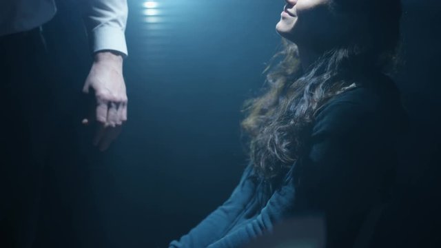 Handcuffed woman being interrogated & intimidated by aggressive cop or gangster