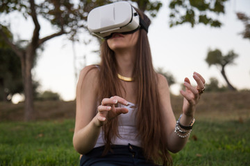 Young woman enjoying experience in VR glasses 