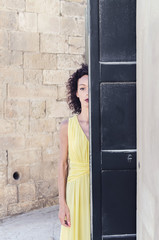 Portrait of woman with half face covered with door