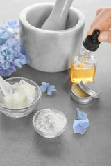 Woman preparing deodorant on table