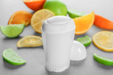 Deodorant for women and citrus fruits on table