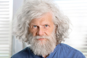 Mature man with grey hair indoors