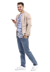 Naklejka premium Young handsome man with mobile phone against white background