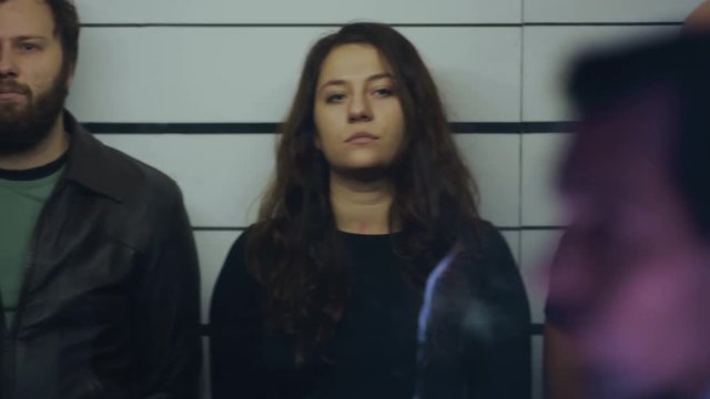  Line up of suspects in identity parade with police officer looking