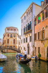 Fototapeta na wymiar Traditional narrow canal with gondolas in Venice, Italy