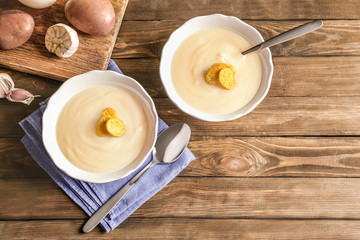 Potato cream soup in bowls on table
