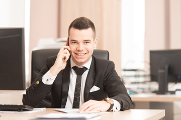 Businessman in Office Talking on Phone