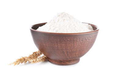 Bowl with flour on white background