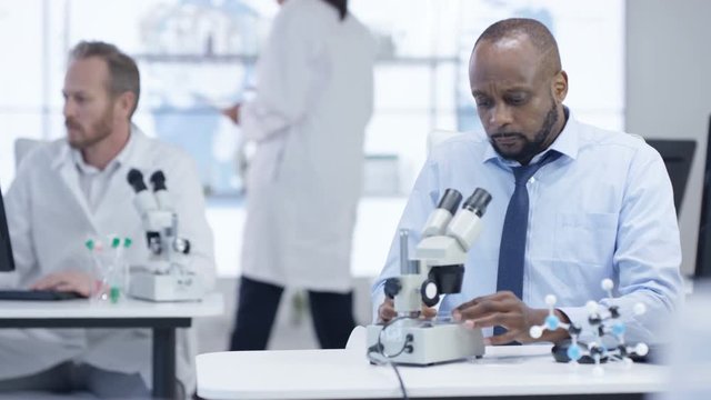  Medical research team in the lab, working on computers & analyzing samples