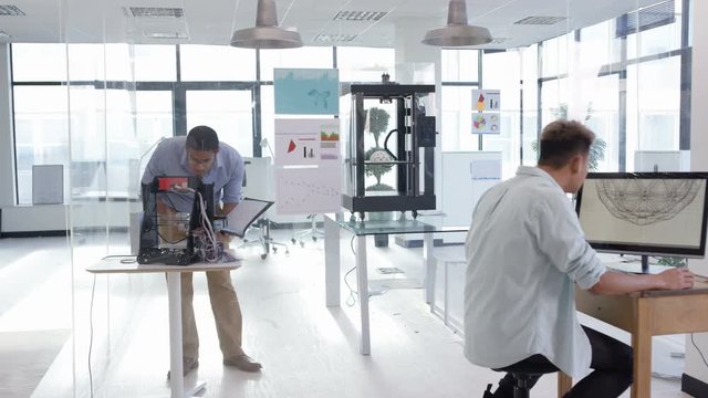  Engineering or design team creating 3D printed objects from computer software