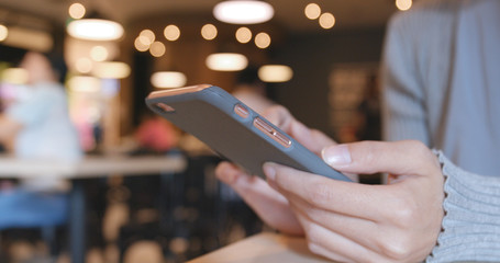 Using smart phone in the coffee shop