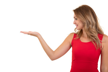 Fototapeta premium Woman pointing at sign. Young beautiful sexy woman showing copy space on empty blank sign or gift card.