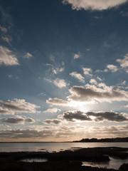 beautiful sunset over harbour coast sea bay clouds silhouette landscape