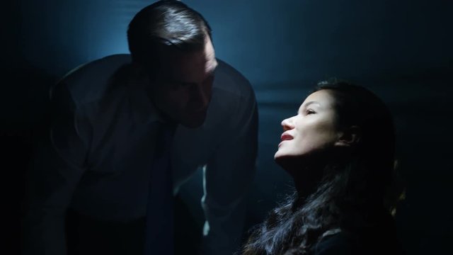  Woman being interrogated & intimidated by aggressive cop or gangster.