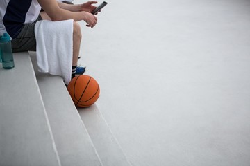 Basketball player using mobile phone