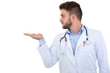 Portrait of a smiling male doctor pointing finger away isolated on a white background