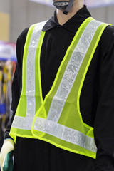 a yellow mesh safety vest with reflective tape.