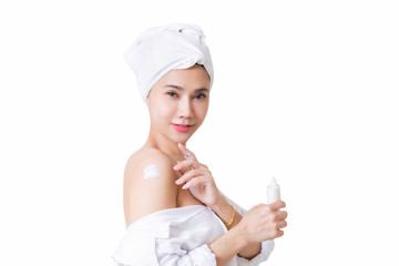 Beautiful girl in bath towel is applying cream on her shoulder. with clipping path