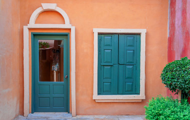 Fototapeta na wymiar Vintage green window and door on orange wall