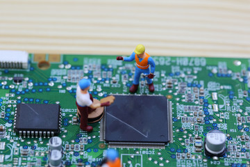 Selective focus of miniature engineer and worker fixed chip of  mainboard computer and use for business background.