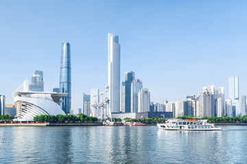 Obraz premium White tourist boat sailing along the Pearl River in Guangzhou