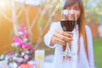 Young asian woman holding glass of red wine at christmas party,christmas concept.
