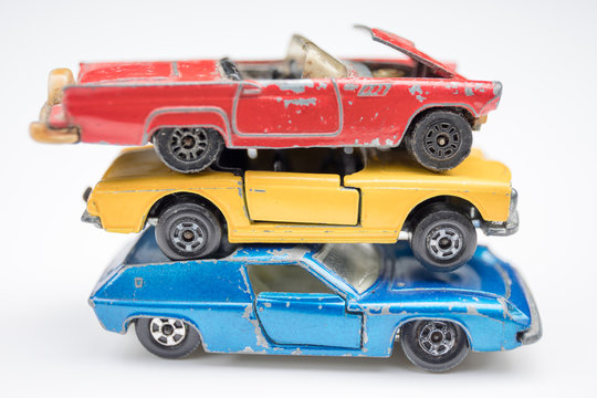Child's old toy cars in primary colors of red, yellow and blue