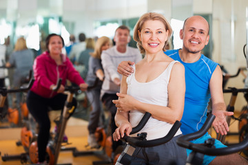 Elderly couple exercising in gym