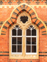 Decorative old window in building made of bricks