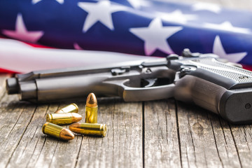 Pistol bullets, handgun and USA flag.