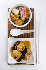 Chicken and herb soup in pot, Chinese food style.