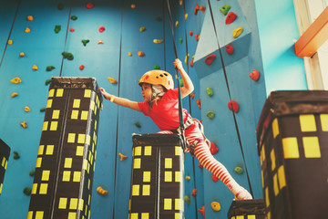 little girl climbing in sport center