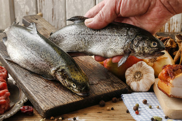 Cook holding a rainbow trout.