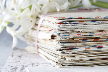 Stack of vintage letters and hyacinth flower.