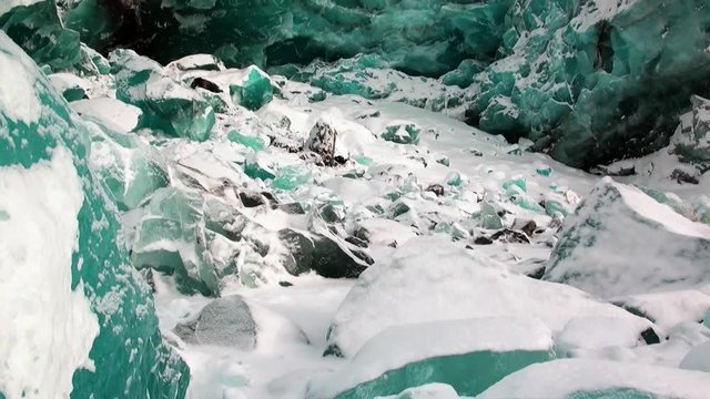 Glacier of beautiful unique turquoise color on background of snow in Arctic. Amazing ice desert landscape. Silence quiet of wilderness North Pole Way to Pyramid on Spitsbergen Svalbard in Norway.