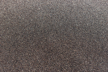 Black sand on the beach. Background and texture