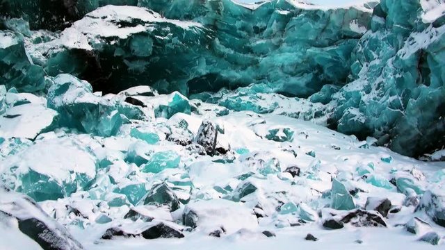 Glacier of beautiful unique turquoise color on background of snow in Arctic. Amazing ice desert landscape. Silence quiet of wilderness North Pole Way to Pyramid on Spitsbergen Svalbard in Norway.