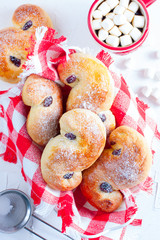 Traditional swedish buns in christmas setting. A saffron bun, in Swedish lussebulle or lussekatt.