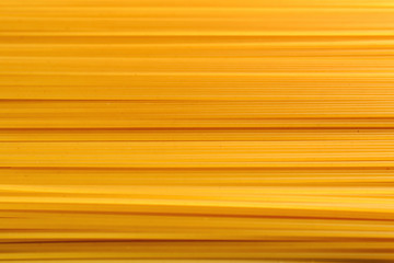 background of spaghetti lying horizontally. yellow pasta as back
