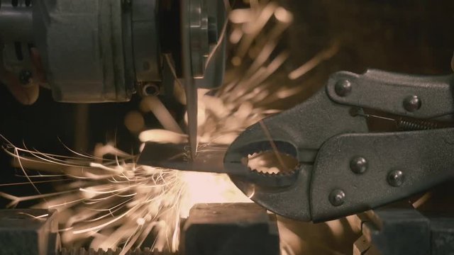 Angle Grinder cuts steel plate
