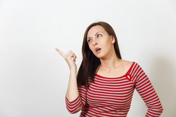 Pretty European young worried and pensive brown-haired woman with healthy clean skin, dressed in casual red and grey clothes lost in thought and conjectures, on a white background. Emotions concept.