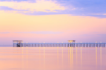 Obraz premium Old wood bridge pier against beautiful sunset sky use for natural background ,backdrop and multipurpose sea scene