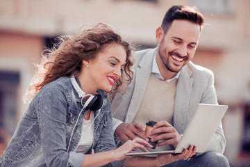 Happy couple using laptop.