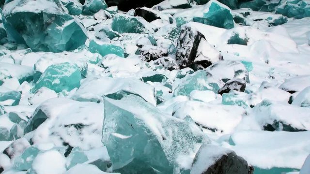 Glacier of beautiful unique turquoise color on background of snow in Arctic. Amazing ice desert landscape. Silence quiet of wilderness North Pole Way to Pyramid on Spitsbergen Svalbard in Norway.