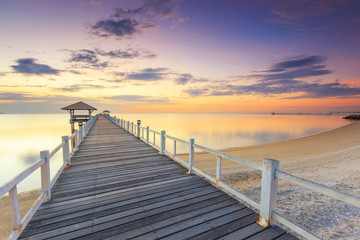 Old wood bridge pier  against beautiful sunset sky use for natural background ,backdrop and multipurpose sea scene