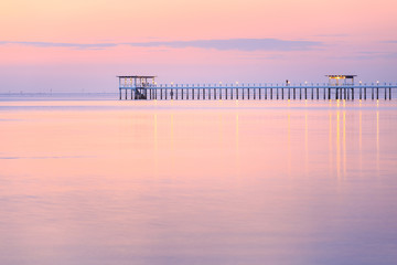 Obraz premium Old wood bridge pier against beautiful sunset sky use for natural background ,backdrop and multipurpose sea scene
